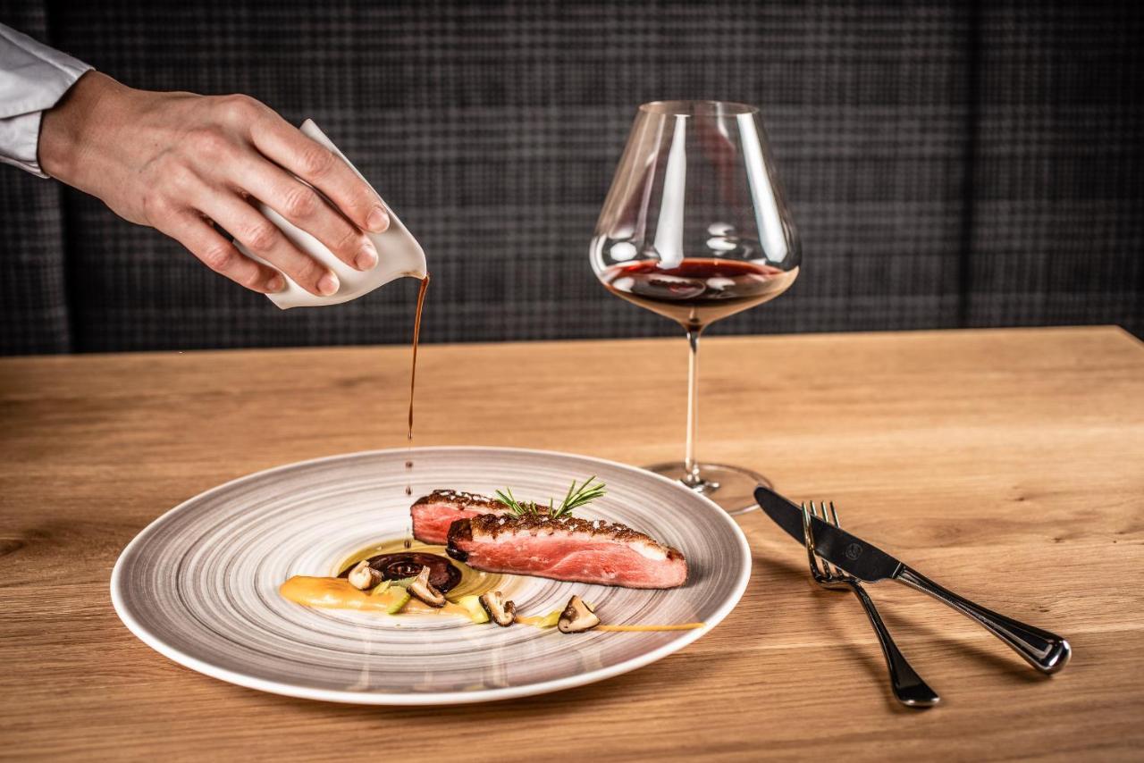 My Arbor - Dolomites Hotell Brixen Exteriör bild A server pouring sauce onto a prepared dish